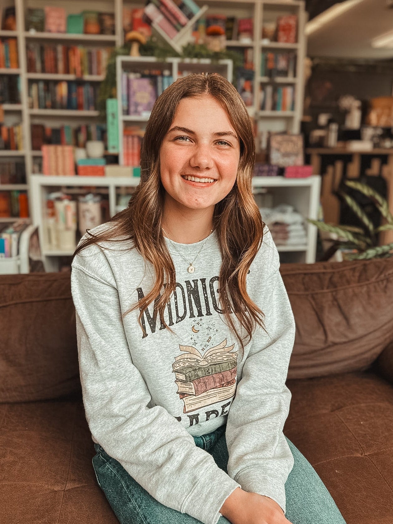 Person sitting on a couch in a bookstore